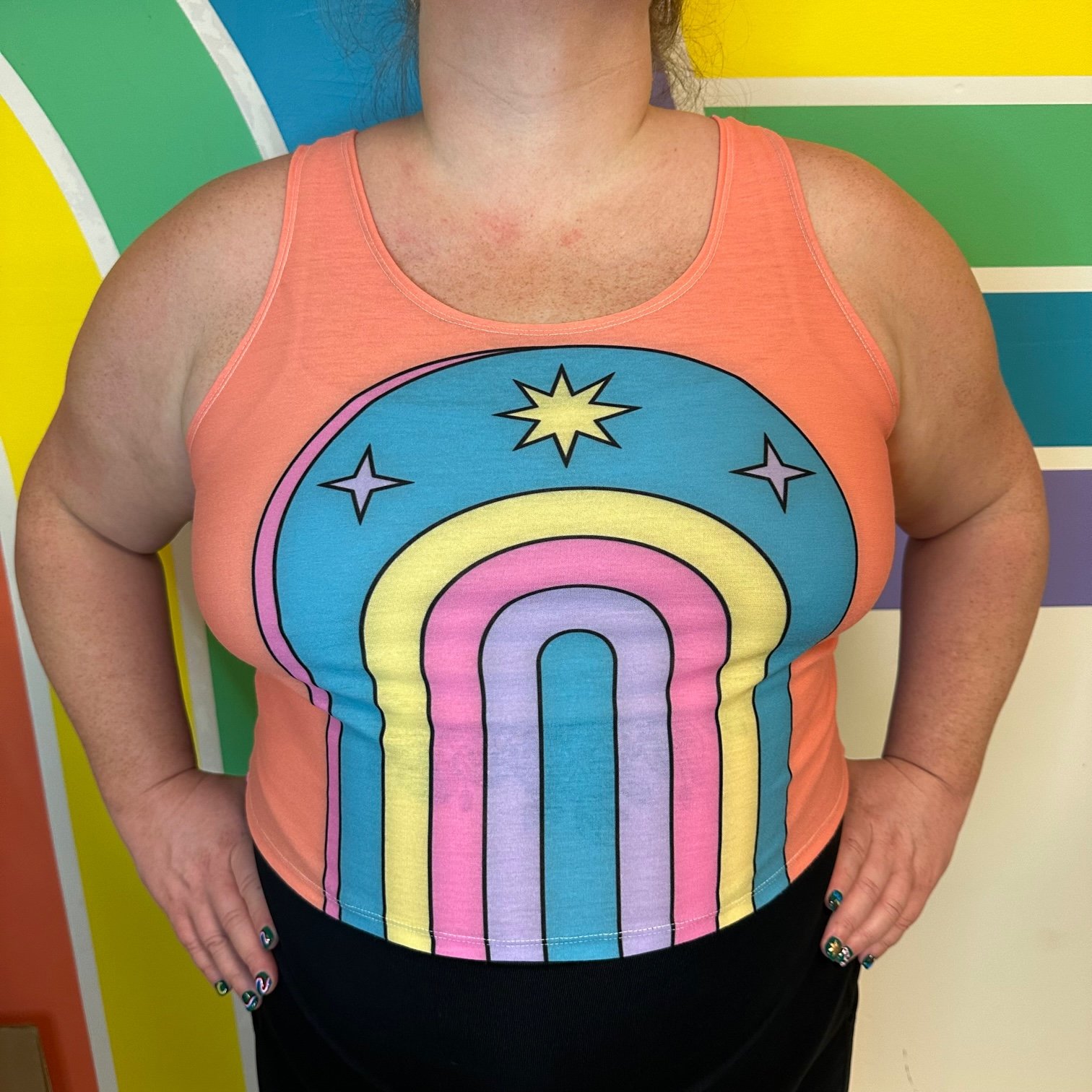 Front view of the pastel paradise crop top by left turn clothing. featuring a rainbow on front