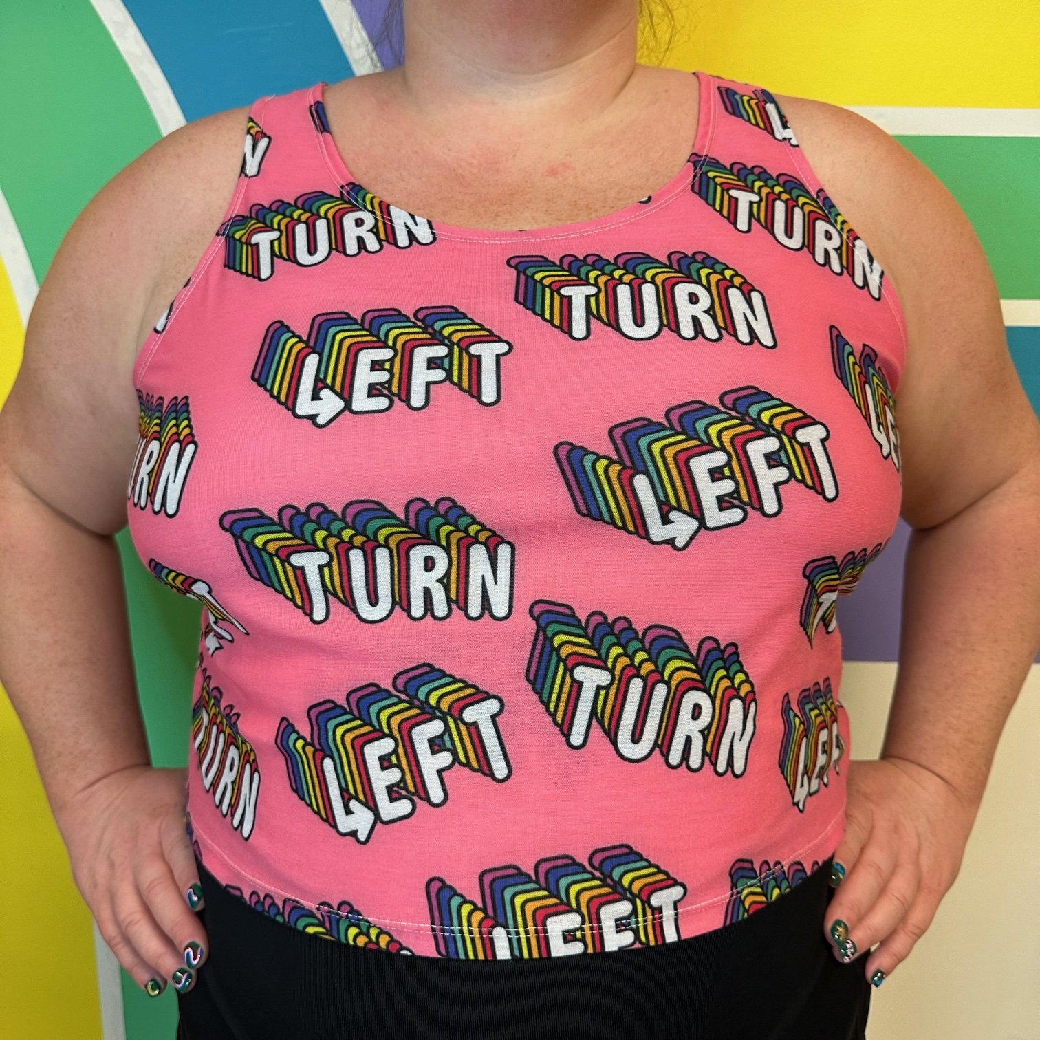 Front view of LEFT TURN rainbow and pink crop top by Left Turn Clothing.